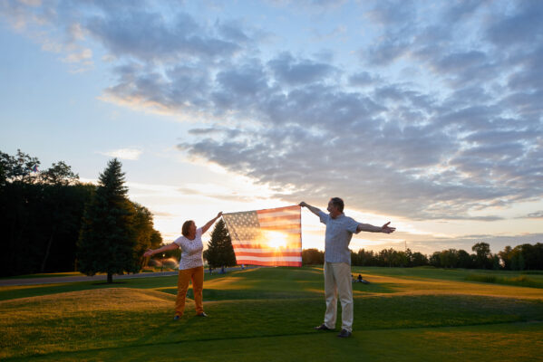 mature couple holding the flag of the united state 2021 09 04 16 06 34 utc scaled 1