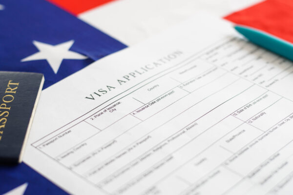 woman filling visa application form american flag 2022 10 18 16 56 21 utc scaled 1